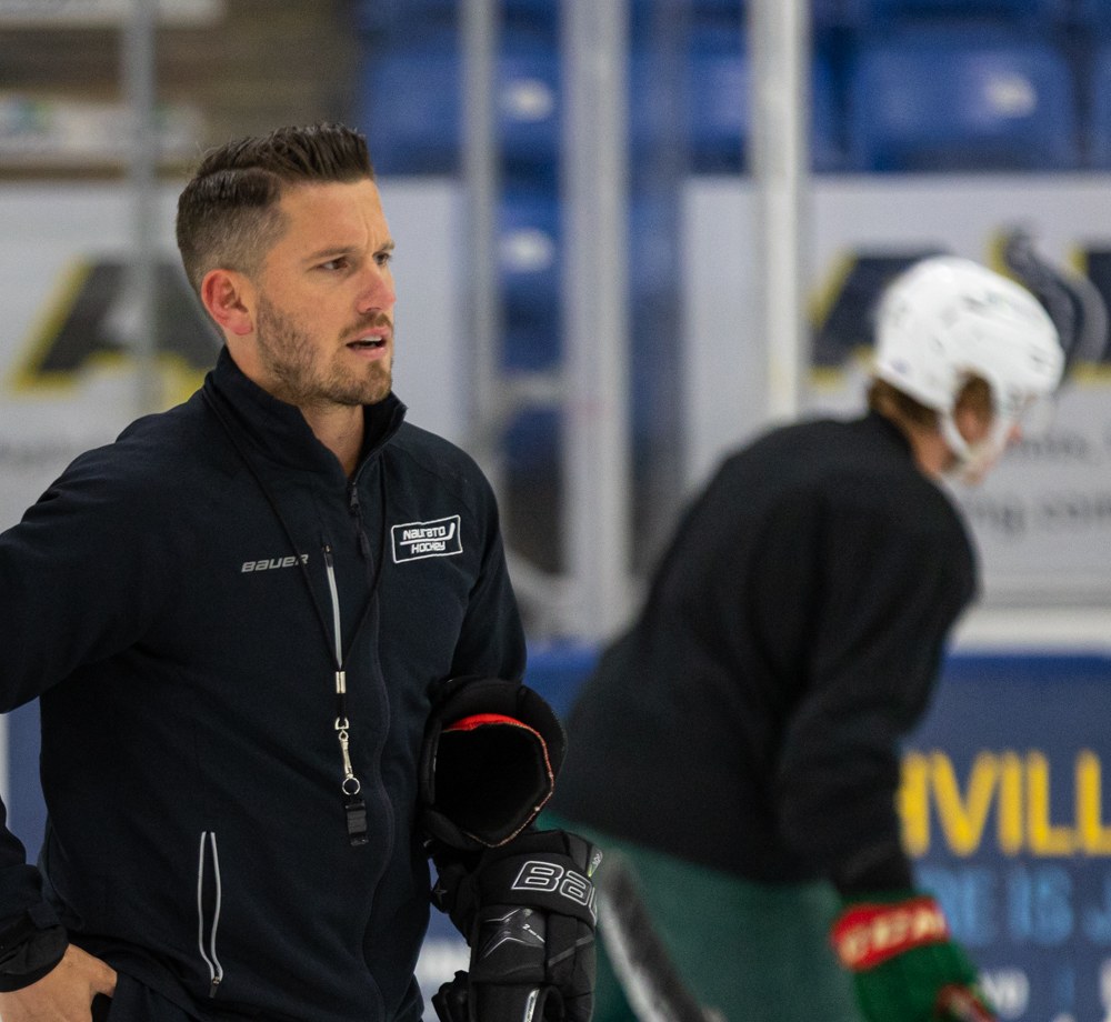 Matthew Larke coaching on the ice